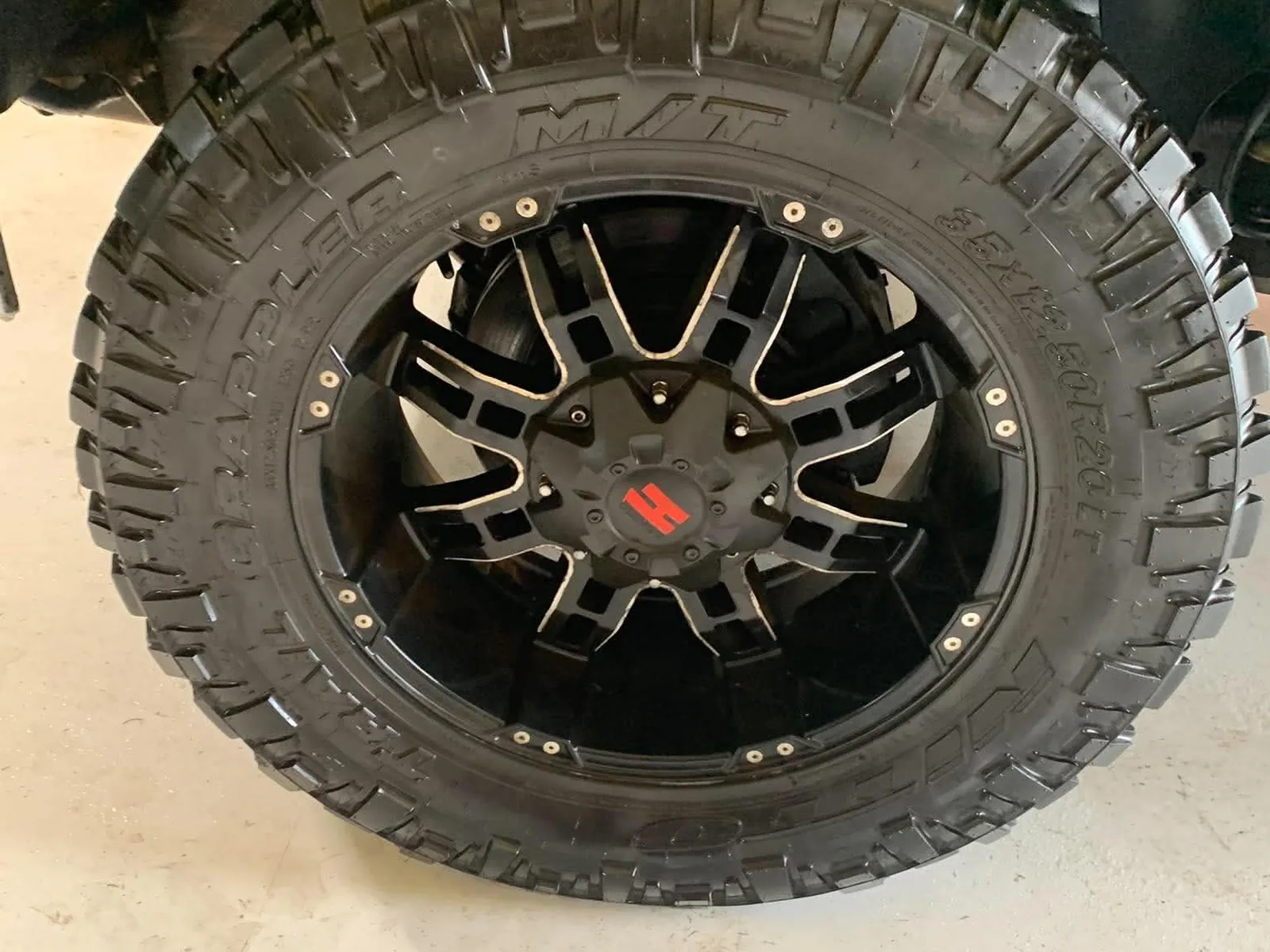 The same truck wheel after detailing, with a deep black tyre and clean polished rim