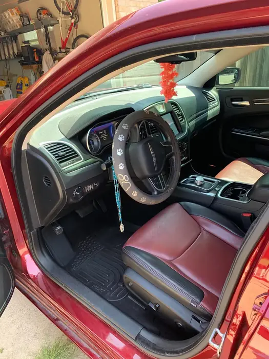 Red Chrysler sedan with freshly cleaned red and black leather interior, driver door open