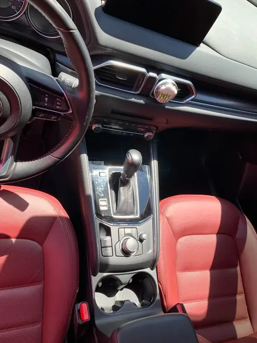 Detailed centre console and gear selector with red leather trim