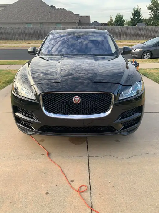Black Jaguar SUV detailed and shining in a car park