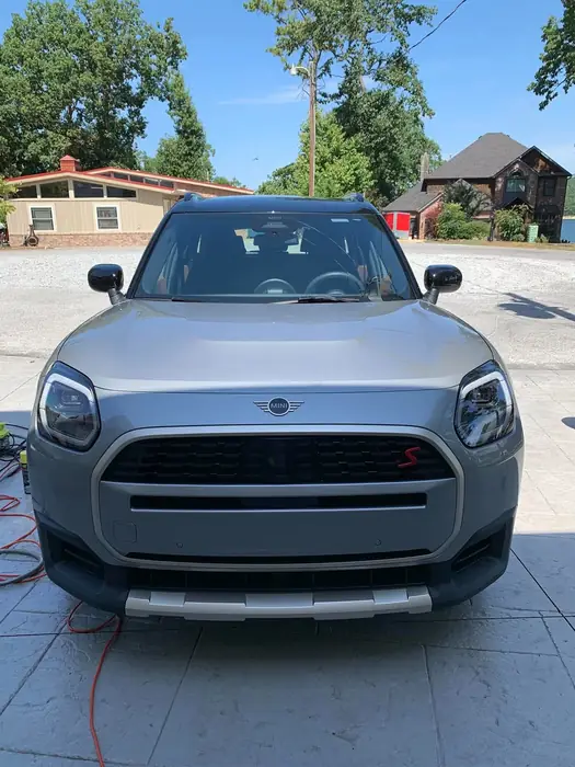 Silver sedan rinsed and drying after an exterior wash