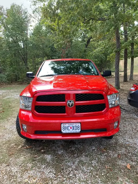 Red Dodge Ram pickup seen head-on after a full exterior detail