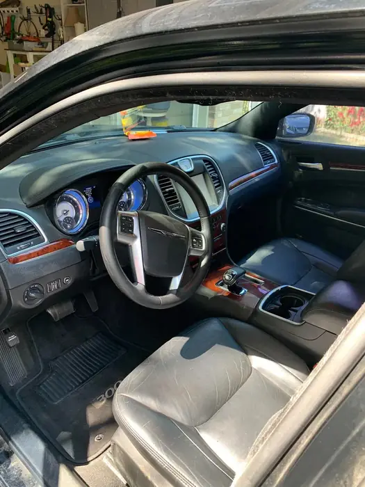Detailed dashboard and front seats seen through the open driver door