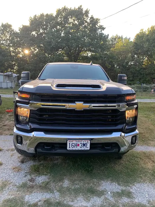 Chevrolet Silverado washed and parked under trees