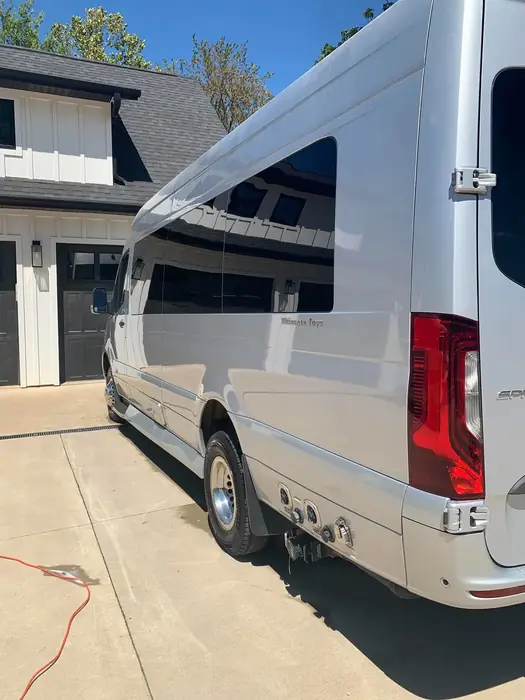White Mercedes-Benz Sprinter van washed and gleaming in a driveway